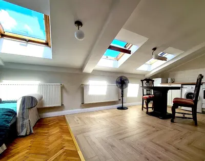 a living room with skylights and a bed and a desk at WANNA SPA na Starym Mieście in Kraków
