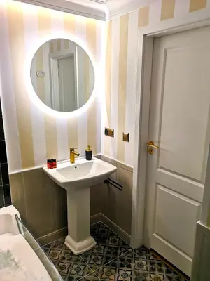 a bathroom with a white sink and a mirror at WANNA SPA na Starym Mieście in Kraków