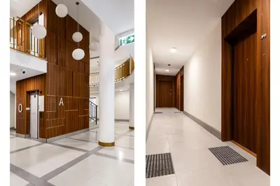 a corridor in a building with wooden doors at Househost Apartment Smoleńsk 33-309A in Kraków