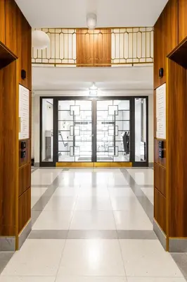 an empty hallway with a large glass door in a building at Househost Apartment Smoleńsk 33-309A in Kraków