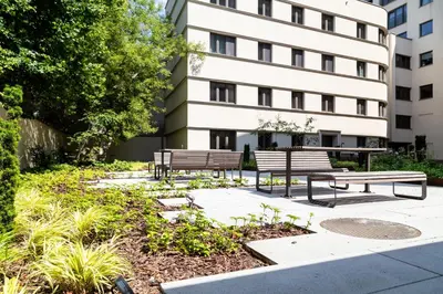 two benches in front of a building at Househost Apartment Smoleńsk 33-309A in Kraków