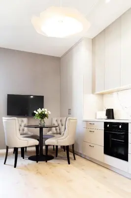 a kitchen with a table with chairs and a tv at Househost Apartment Smoleńsk 33-309A in Kraków