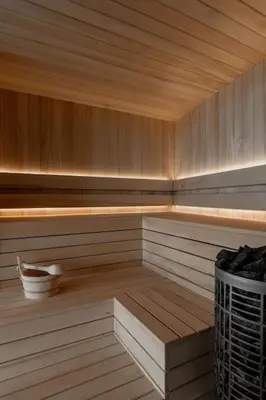 a sauna with a wooden floor and a bucket in it at Poczywaj in Jordanów