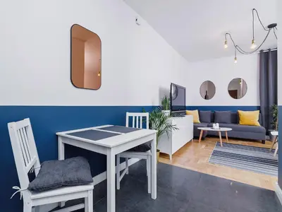 a living room with a table and a couch at Kazimierz- Warszauera 3 Street in Kraków