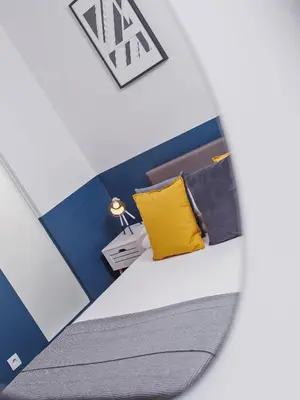 a room with a bed with a yellow pillow at Kazimierz- Warszauera 3 Street in Kraków