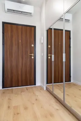 an empty room with two wooden doors and wooden floors at Househost Apt Smoleńsk 33-308A in Kraków