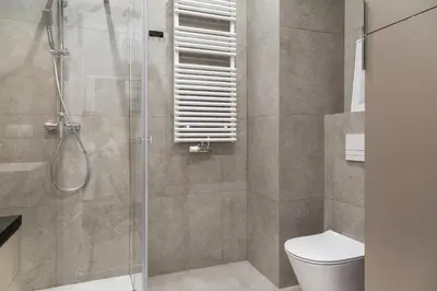a bathroom with a shower and a toilet at Househost Apt Smoleńsk 33-308A in Kraków