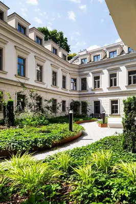 a large building with a garden in front of it at Househost Apt Smoleńsk 33-308A in Kraków