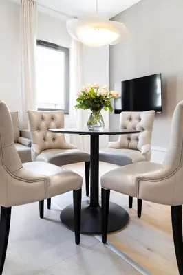 a living room with a table and chairs at Househost Apt Smoleńsk 33-308A in Kraków
