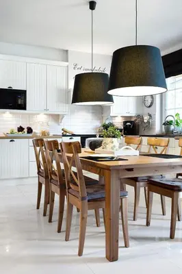a kitchen with white cabinets and a counter with a cutting board at Villa Teresa in Trzebinia