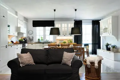 a kitchen and dining room with a table and chairs at Villa Teresa in Trzebinia