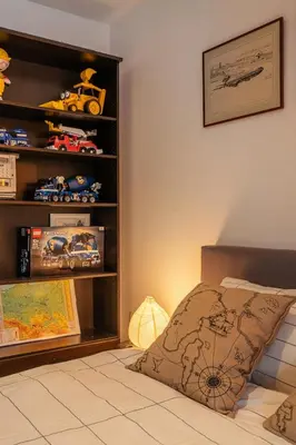 a living room with a table and a book shelf at Villa Teresa in Trzebinia