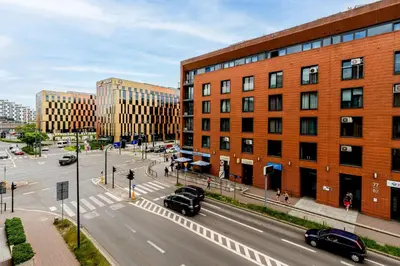 a city street with cars driving down a street at Modern Apartments II with FREE underground parking in Kraków