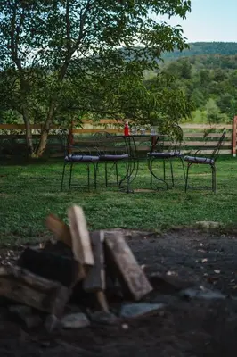 a group of chairs and a table in a park at Chata pod Szczeblem in Lubień