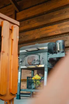 an old stove in a room with wooden walls at Chata pod Szczeblem in Lubień