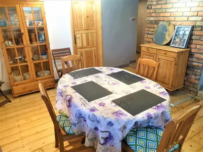 a dining room with a table with a quilt on it at Dom pod Wieliczką in Wieliczka