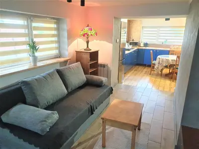 a living room with a couch and a table at Dom pod Wieliczką in Wieliczka