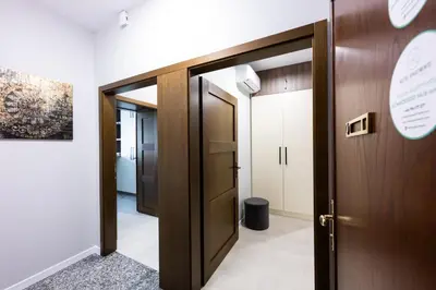 a corridor with a wooden door and a hallway at Native Apartments Słowackiego 14/6 Superior in Kraków
