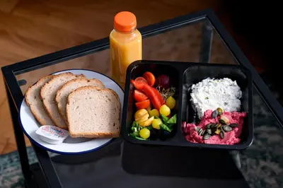 a tray of food with a plate of bread and vegetables at Native Apartments Słowackiego 14/6 Superior in Kraków