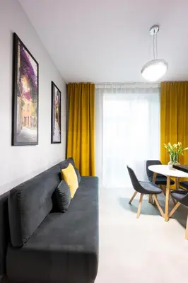 a kitchen with white cabinets and a black counter top at Native Apartments Słowackiego 14/6 Superior in Kraków