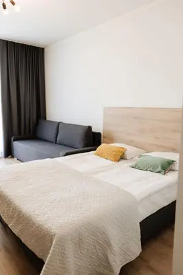 a bedroom with two beds and a couch at Zakrzówek Residence in Kraków