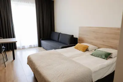 a hotel room with a bed and a chair at Zakrzówek Residence in Kraków