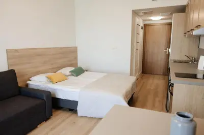 a small room with a bed and a couch at Zakrzówek Residence in Kraków