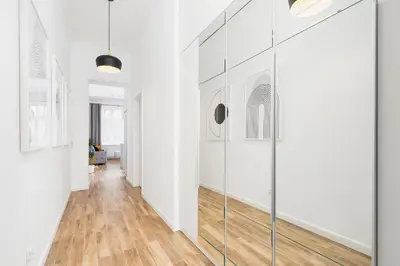 a hallway with white walls and a glass door at Apartment with balcony - Starowislna 41 in Kraków