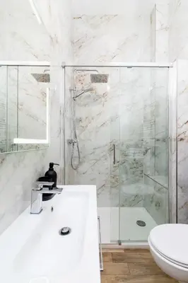a white bathroom with a shower and a sink at Apartment with balcony - Starowislna 41 in Kraków