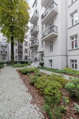 an apartment building with a walkway in front of it at Apartment with balcony - Starowislna 41 in Kraków