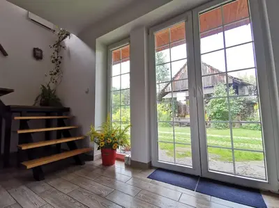 a room with sliding glass doors and a staircase at Bluszcz i Lawenda in Jankowice