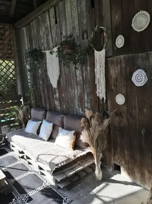 a couch sitting against a wooden wall at Bluszcz i Lawenda in Jankowice