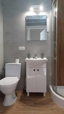 a bathroom with a toilet and a sink and a shower at Good Apartament Skawina in Skawina