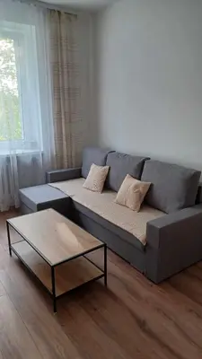a living room with a couch and a coffee table at Good Apartament Skawina in Skawina