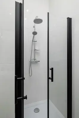 a bathroom with a shower with a glass door at Balcony Apartment - Kazimierz- 41 Starowislna Street in Kraków