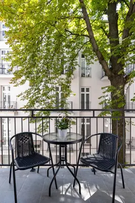 a table and chairs on a balcony with a building at Balcony Apartment - Kazimierz- 41 Starowislna Street in Kraków
