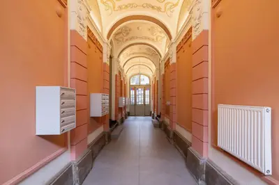 a hallway in a building with orange walls and a ceiling at Balcony Apartment - Kazimierz- 41 Starowislna Street in Kraków