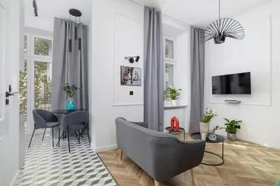 a living room with a table and a couch at Balcony Apartment - Kazimierz- 41 Starowislna Street in Kraków