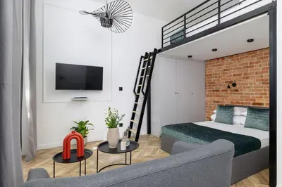 a bedroom with a loft bed and a couch at Balcony Apartment - Kazimierz- 41 Starowislna Street in Kraków