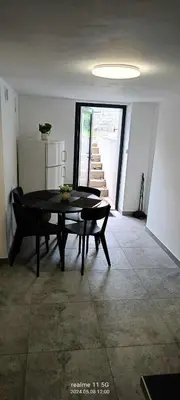 a living room with a table and a staircase at piąteczka in Niepołomice