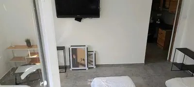 a room with a mirror and a tv on a wall at piąteczka in Niepołomice