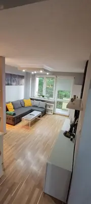 a living room with a couch and a table at Apartament Olsza in Kraków