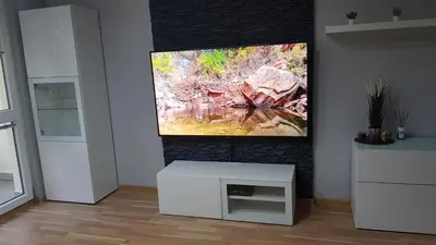 a living room with a flat screen tv on a fireplace at Apartament Olsza in Kraków