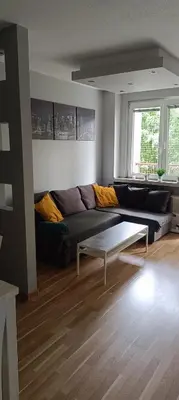 a living room with a couch and a coffee table at Apartament Olsza in Kraków