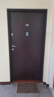 a wooden door with a metal grate in front of it at Apartament Olsza in Kraków