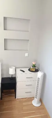 a white desk in a room with a lamp at Apartament Olsza in Kraków