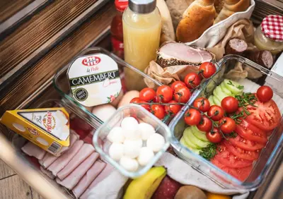 a lunch box with vegetables and cheese and other foods at Domki pod Krakowem - Stare Sady in Kopytówka