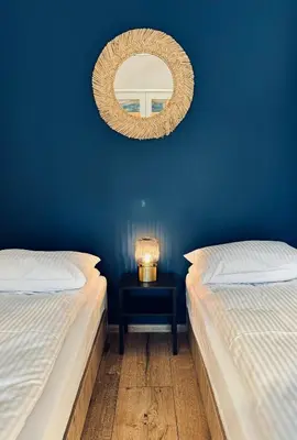 a blue room with two beds and a mirror at Domki pod Krakowem - Stare Sady in Kopytówka