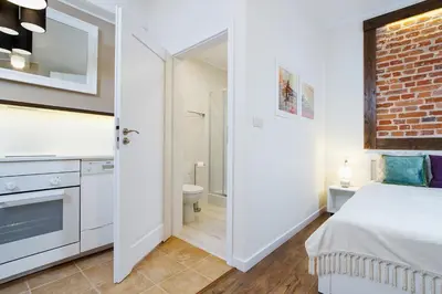 a bedroom with a bed and a bathroom at Apartment for two-Jewish Quarter-Starowiślna 54 in Kraków