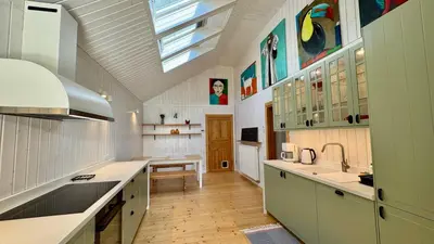 a large kitchen with a skylight and a ceiling at Dom w Starym Sadzie z basenem i sauną - Beskid Wyspowy in Nowe Rybie
